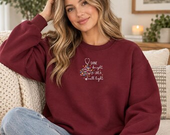 Christmas Nurse Sweatshirt, Shine Bright Like a Call Light Embroidered Crewneck, Nurse Christmas Gift, Holiday Healthcare Sweatshirt