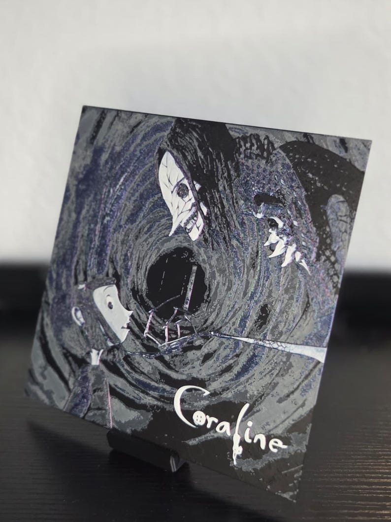 May include: A square print with a scene from the film "Coraline." The image shows a character confronting a threatening figure against a swirling, dark backdrop. The title "Coraline" is written in white script at the bottom.