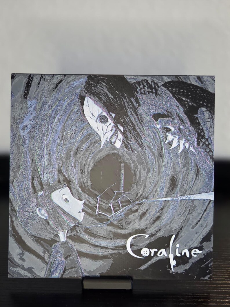 May include: A square artwork in monochrome depicting scenes from the film "Coraline." It shows a girl facing a tall, dark figure with a skull-like mask. The word "Coraline" is written in white script with a button replacing the letter "o."