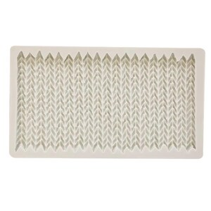 May include: A rectangular off-white silicone mold featuring a repeating vertical V-shaped texture that mimics the appearance of a knitted fabric pattern. The mold has a smooth, flat border surrounding the textured interior surface.