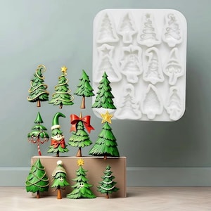 May include: A white silicone mold featuring twelve distinct Christmas tree cavities, accompanied by twelve corresponding green, three-dimensional Christmas tree figurines with various decorative details like gold stars, red bows, and hats.