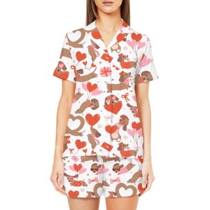 May include: White pajama set featuring a pattern of brown dachshunds, red hearts, and pink balloons. The short-sleeved top has a collared neckline and button-up front. The shorts have an elastic waistband. The pajama set is made of a soft, lightweight fabric.