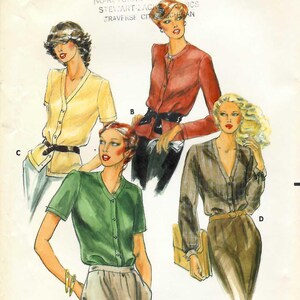 May include: Vintage Butterick sewing pattern 6807, size 12, featuring illustrations of four different blouse designs. The pattern includes a yellow, red, green, and brown blouse. The text "BUTTERICK" and "6807" are at the top.
