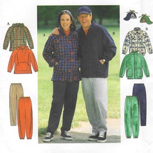 May include: Simplicity sewing pattern 7854 featuring a couple wearing jackets, pants, and hats. The pattern includes a plaid jacket, an orange hoodie, and various pants. The text "Simplicity" is displayed in large, bold letters.