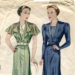 May include: A vintage Simplicity sewing pattern for a dress. The pattern is for size 42 bust and 45 hip. The pattern shows two women wearing the dress, one in green with white polka dots and the other in blue. The pattern is from the 1940s.