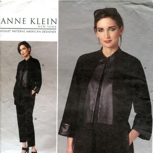 May include: A black Anne Klein Vogue Patterns sewing pattern. The pattern features a woman wearing a black jacket with leather accents and matching pants. The pattern number is V1264, size EE (14-16-18-20).