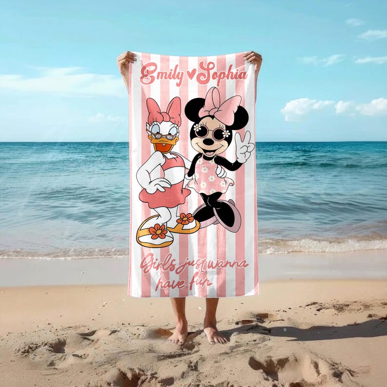 May include: A pink and white striped beach towel featuring Daisy Duck and Minnie Mouse. The towel has the text "Emily Sophia" and "Girls just wanna have fun". The characters are wearing sunglasses and dresses.