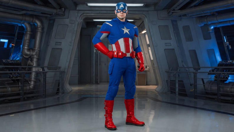 K&ouml;nnte beinhalten: Eine Person in einem Captain America-Kost&uuml;m, &uuml;berwiegend blau, rot und wei&szlig;. Das Kost&uuml;m hat einen Stern und einen Helm. Die Person tr&auml;gt rote Handschuhe und Stiefel. Die Kulisse scheint ein futuristisches Interieur zu sein.