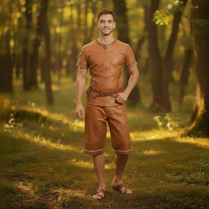 May include: A brown leather outfit consisting of a short-sleeved top, shorts, and a belt. The top has a zipper and decorative studs around the neckline and sleeves. The shorts have decorative studs around the hem. The outfit is worn with brown sandals.