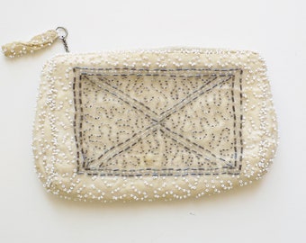 1920s beaded clutch purse with zipper closure, and and beaded pull tab on chain / lined in ivory satin / minor bead loss / white and silver