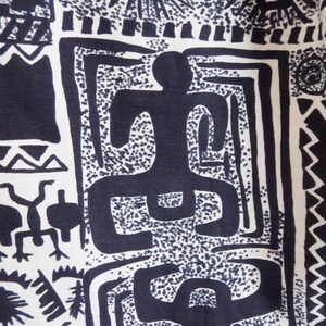 Pu&ograve; includere: Tessuto bianco e nero con un motivo ripetitivo di forme geometriche e figure stilizzate. Il tessuto presenta un disegno di una persona con braccia e gambe distese, circondata da forme astratte.