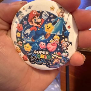 May include: A set of three ceramic mugs with a speckled, matte finish. The mugs are in shades of cream, light gray, and dark gray. Each mug has a simple, minimalist design and a rounded handle.