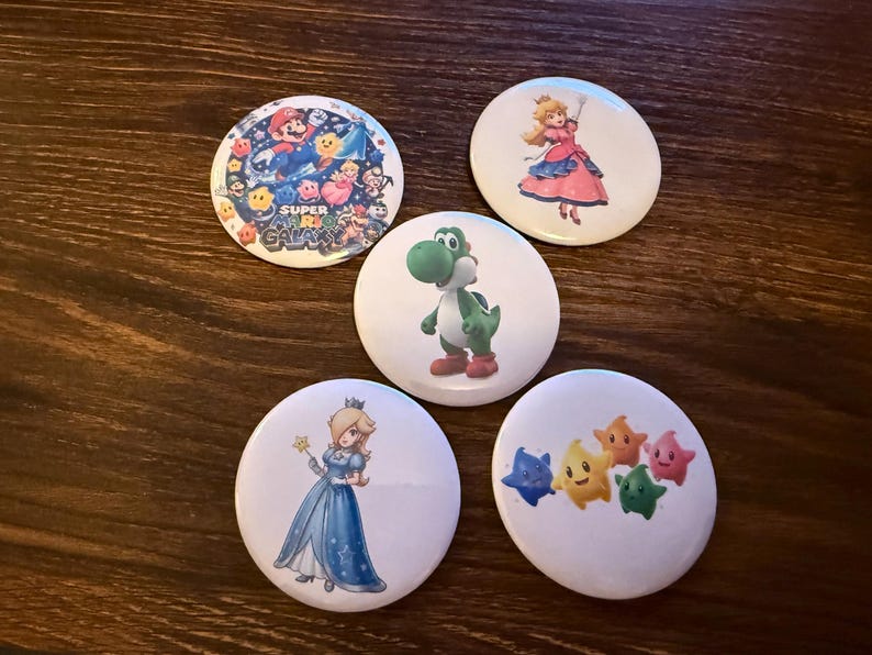 May include: A white ceramic mug with a black handle and the text "But First, Coffee" in a black, bold font. The mug is sitting on a white surface. The mug is approximately 4 inches tall.