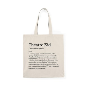 Puede incluir: Bolso tote beige con texto negro "Theatre Kid" y una definición de diccionario. La definición describe a un joven actor con pasión por la actuación, incluyendo la obsesión por las obras escolares y los musicales.
