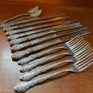 ROSE Service Merchandise | vintage silverware | intricate rose design | black accent handle | floral pattern stainless flatware | floral tip