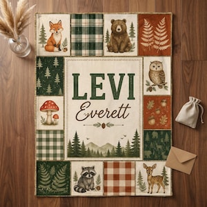 May include: A rectangular patchwork blanket featuring a central cream panel with the name LEVI Everett in dark green and brown text. The border includes illustrations of a fox, bear, owl, raccoon, deer, mushrooms, pine trees, and plaid patterns.