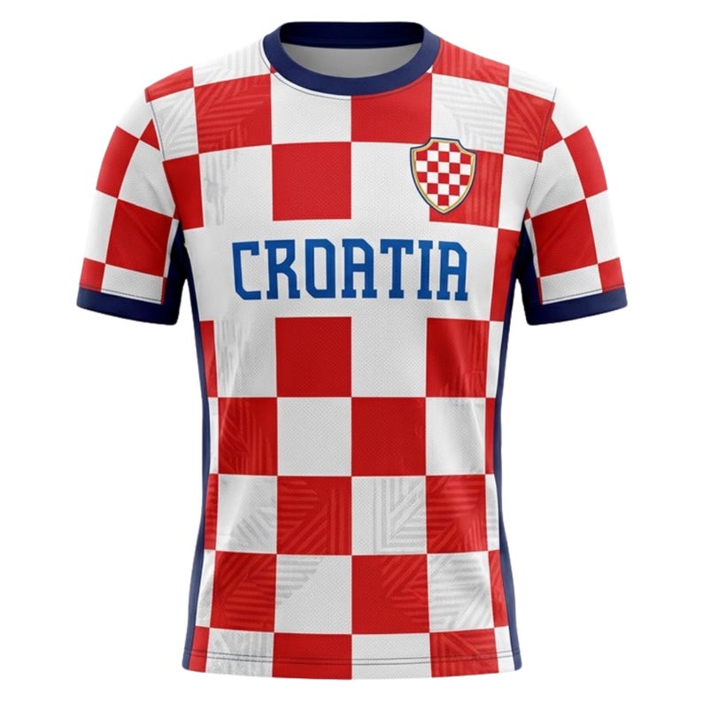 May include: A Croatia soccer jersey with a red and white checkered pattern. The jersey has blue accents on the collar, sleeves, and sides. The word "CROATIA" is printed in blue across the chest, with a team crest on the upper chest.
