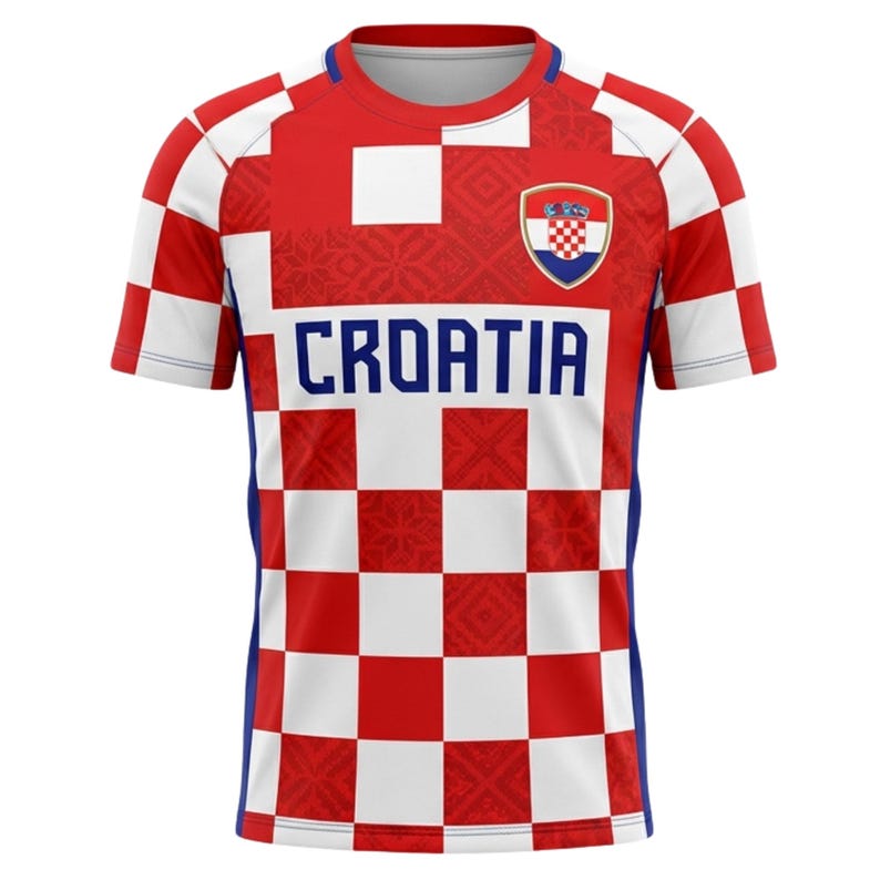 May include: A Croatia soccer jersey with a red and white checkered pattern. The jersey features the word "CROATIA" in blue block letters across the chest, and a Croatian coat of arms emblem. The sleeves and sides have blue accents.