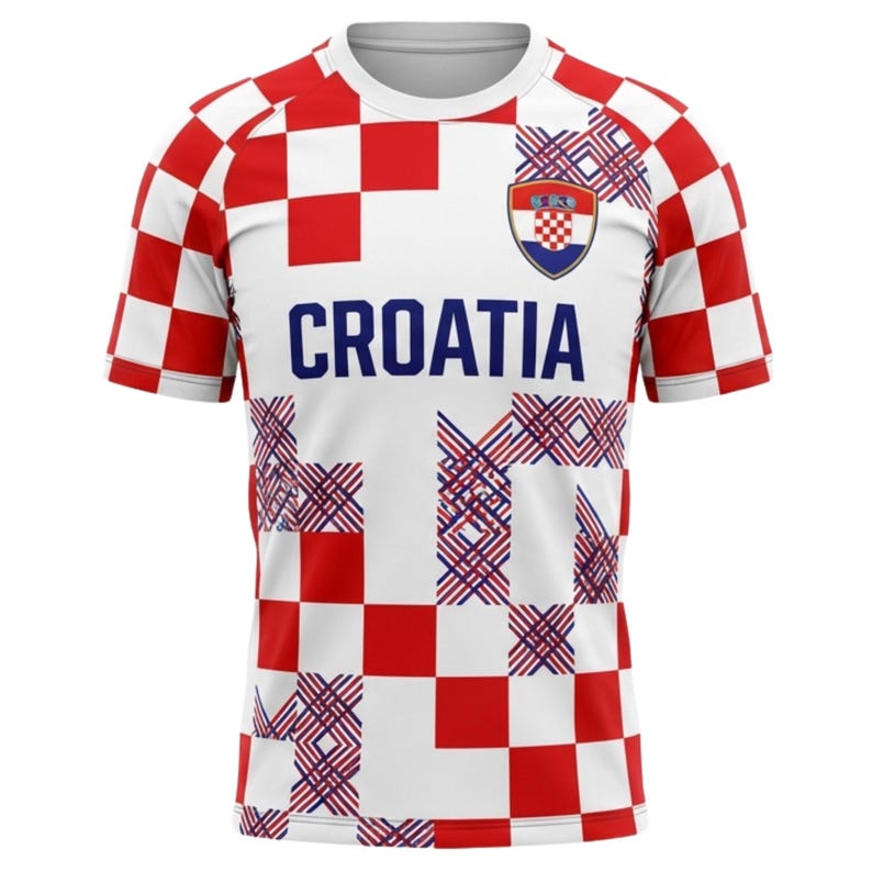 May include: A white and red checkered Croatia soccer jersey with the word "CROATIA" in blue block letters. The jersey has a team crest and a pattern of intersecting lines.
