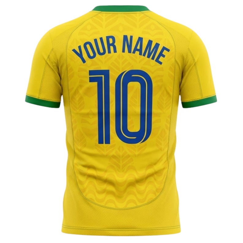 Puede incluir: Camiseta de f&uacute;tbol amarilla con ribetes verdes y el texto "YOUR NAME" sobre el n&uacute;mero "10" en azul. La camiseta tiene un patr&oacute;n sutil y probablemente est&aacute; hecha de una tela transpirable.