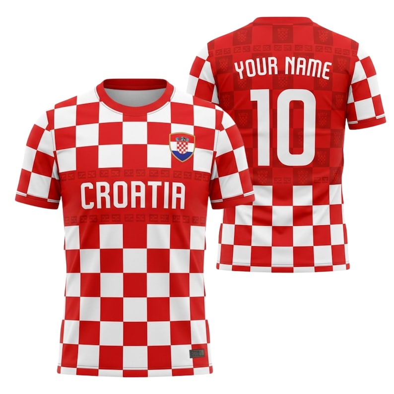 May include: A red and white checkered Croatia soccer jersey. The front of the jersey displays the word "CROATIA" in white block letters, and a Croatian coat of arms. The back has the number "10" in white and space for a name.