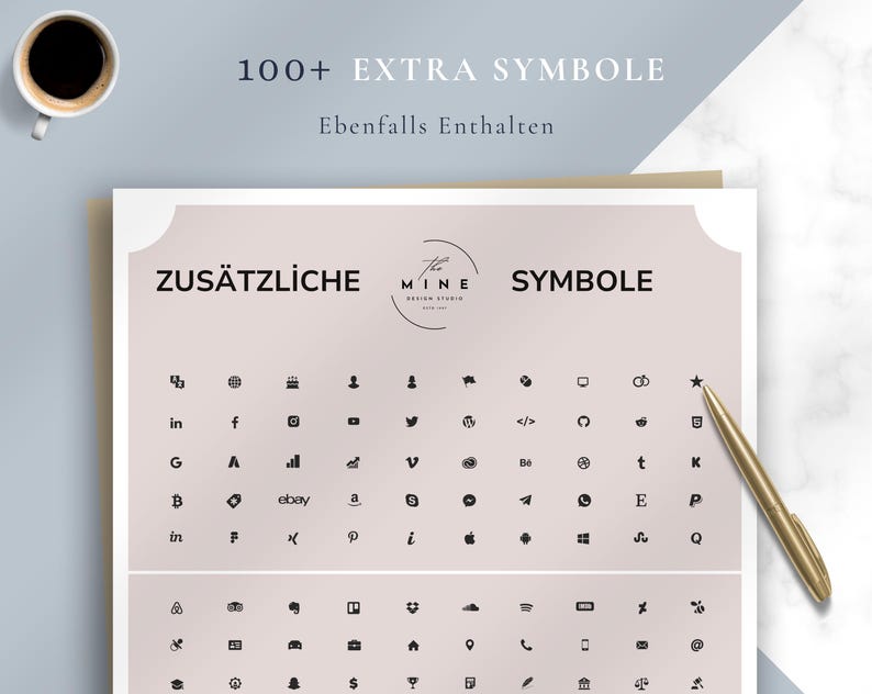 May include: A sheet with various black symbols, including social media icons, arranged on a pink background. The text "ZUS&Auml;TZLICHE SYMBOLE" is at the top, with "100+ EXTRA SYMBOLE" above. A gold pen and a cup of coffee are also visible.