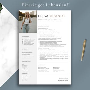 May include: A professional resume template with the name "Elisa Brandt" in gold lettering. The resume includes sections for work experience, skills, and education. A gold pen rests on a blue-gray surface.