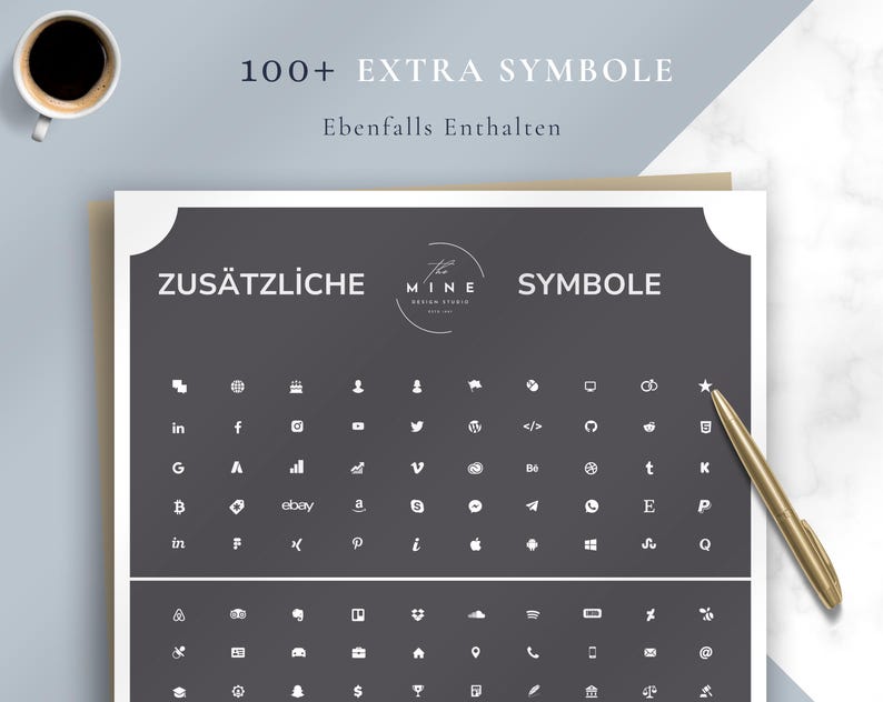 May include: A white paper with a dark gray border displays a collection of white icons and the words "ZUS&Auml;TZLICHE SYMBOLE" and "100+ EXTRA SYMBOLE". A gold pen rests on the paper, and a cup of coffee is in the upper left corner.