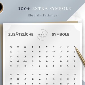 May include: A white sheet with the text "ZUS&Auml;TZLICHE SYMBOLE" and a collection of black icons. The sheet also includes the text "100+ EXTRA SYMBOLE" and "Ebenfalls Enthalten". A gold pen rests on the right side, and a cup of coffee is in the upper left.