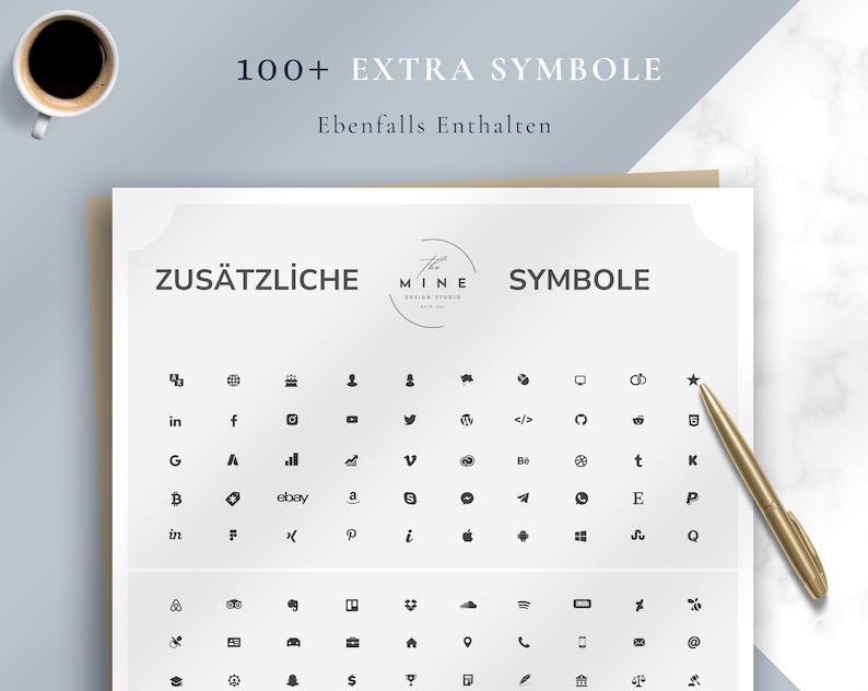 May include: A white sheet with the text "ZUS&Auml;TZLICHE SYMBOLE" and a collection of black icons. The sheet also includes the text "100+ EXTRA SYMBOLE" and "Ebenfalls Enthalten". A gold pen rests on the right side, and a cup of coffee is in the upper left.