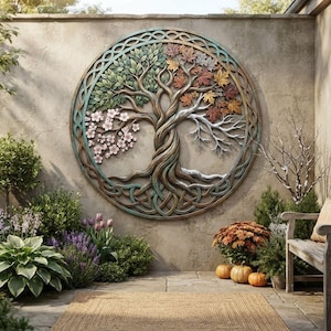 May include: A circular metal wall art piece featuring a tree with four distinct seasonal sections. The tree displays green leaves, pink blossoms, autumn-colored foliage, and bare branches, all enclosed within an intricate Celtic knot border.