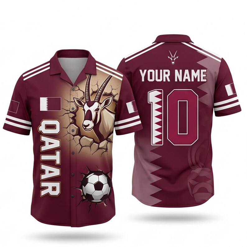 May include: Maroon button-up shirt with white stripes and a Qatar theme. Features a graphic of an oryx breaking through a wall, a soccer ball, and the word "QATAR". The back has the number 10 and space for a name.