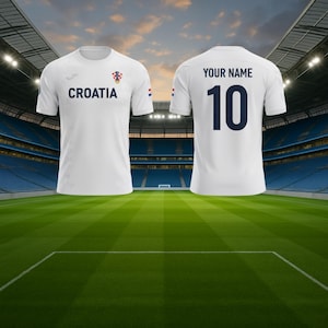 May include: White Croatia football shirt with the word "CROATIA" in navy blue on the front. The shirt also features the Croatian coat of arms and a small Croatian flag. The back of the shirt has the number 10 and the text "YOUR NAME" in navy blue.