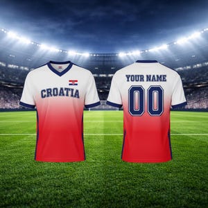 May include: A Croatia football shirt in white, red, and blue. The front displays "CROATIA" and the Croatian flag. The back has "YOUR NAME" above the number "00". The shirt has a V-neck and blue trim.
