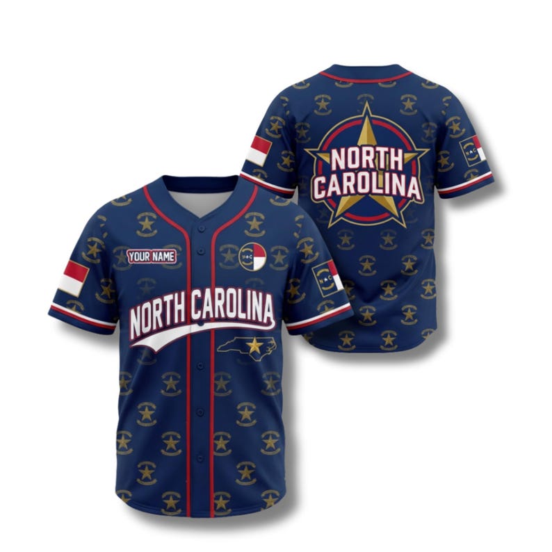 May include: A navy blue baseball jersey with red and white detailing. The jersey displays the text "NORTH CAROLINA" and a star graphic. The back of the jersey has a large star graphic with the words "NORTH CAROLINA". It has a button-up front and short sleeves.