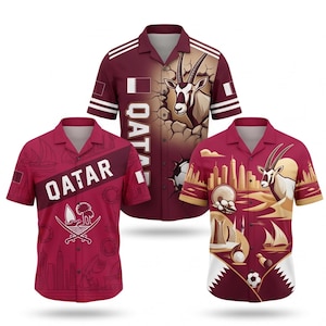 May include: Three maroon short-sleeve shirts with Qatar-themed designs. One shirt features the word "QATAR" and a graphic. Another has an oryx graphic. The third shirt has a skyline and oryx graphic. Each shirt has a collar and button-up front.