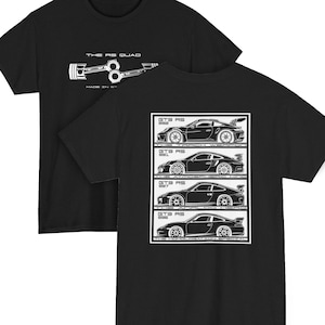 May include: Black t-shirts with white graphics. One shirt features a piston design with the text "THE RS QUAD" and "MADE IN GERMANY". The other shirt displays four car illustrations labeled "GTS RS" with model numbers.