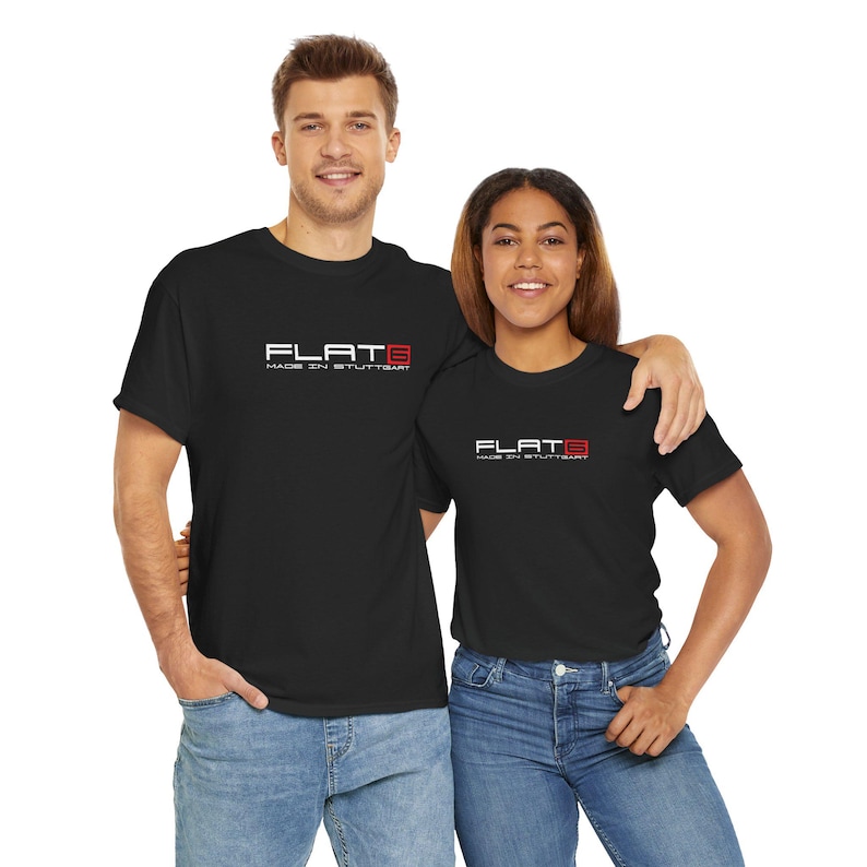 May include: Two people wearing black t-shirts with the text "FLAT 6 MADE IN STUTTGART" in white and red. The t-shirts are paired with blue jeans. The image is taken from the chest up, with a white background.