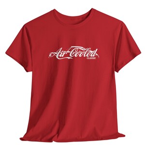 May include: A red t-shirt with the words "Air Cooled Classic" in white script across the front. The design mimics a well-known soda logo. The shirt has short sleeves and a crew neck.