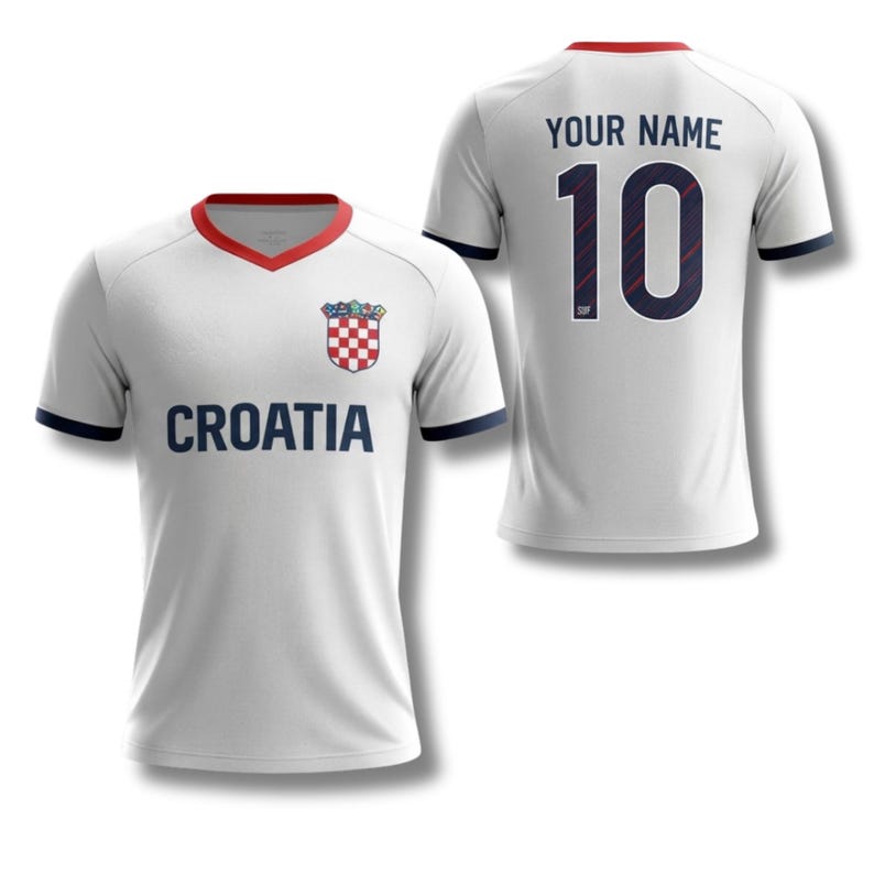 May include: White Croatia football shirt with red and navy blue detailing. The front displays "CROATIA" in navy, a team crest, and a red collar. The back shows "YOUR NAME" above the number "10".