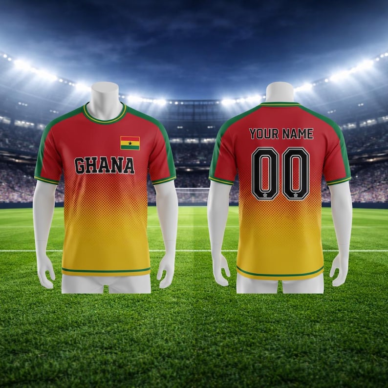 May include: A red, yellow, and green football shirt with "GHANA" and the Ghana flag on the front. The back of the shirt has the number "00" and the words "YOUR NAME". The shirt is displayed on a mannequin.