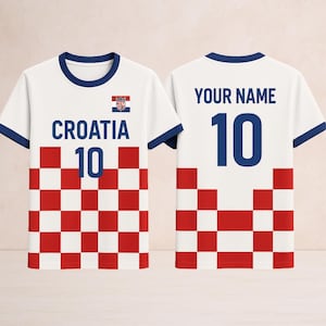 May include: White Croatia soccer jersey with blue trim and the number 10. The front features the word "CROATIA" and a red and white checkered pattern. The back has "YOUR NAME" and the number 10.