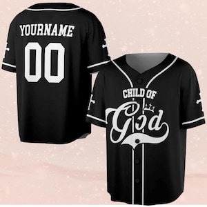 May include: Black baseball jersey with white trim and buttons. The front of the jersey features the words "CHILD OF God" in a stylized font. The back of the jersey has the word "YOURNAME" above the number "00".