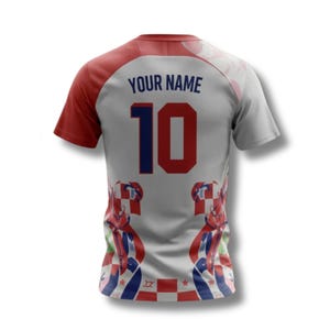 May include: A white and grey football shirt with red sleeves and trim. The number 10 is in blue and red, with "YOUR NAME" above. The shirt has Croatian flag designs on the lower part.