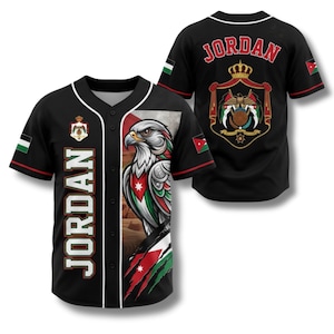 May include: Black baseball jersey with white trim and the word "JORDAN" in white down the front. The jersey features a detailed graphic of an eagle with the Jordanian flag colors and a crest on the back.