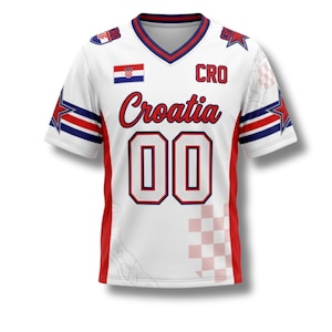 K&ouml;nnte beinhalten: Wei&szlig;es Kroatien-Fu&szlig;balltrikot mit roten und blauen Akzenten. Es zeigt die kroatische Flagge, das Wort "Croatia" in roter Schrift und die Nummer "00". Enth&auml;lt einen V-Ausschnitt und Sterngrafiken auf den &Auml;rmeln.