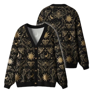 May include: Black cardigan with a V-neck and button closure. The sweater features a repeating gold pattern of moths, moons, suns, and other celestial and botanical elements. The cardigan is displayed from the front and back.