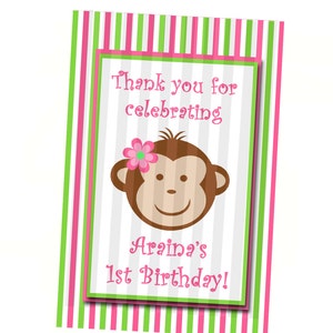 May include: A pink and green striped thank you card with a monkey illustration and the text "Thank you for celebrating Araina's 1st Birthday!"