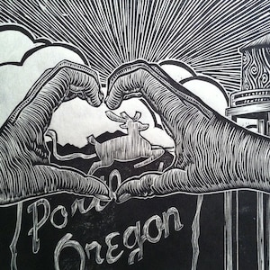 May include: Black and white woodcut print of two hands forming a heart shape around a deer silhouette. The text "Pone Oregon" is below the hands.