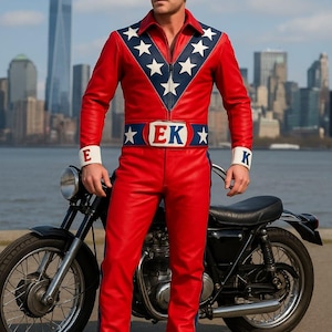 May include: A red leather jumpsuit with a blue and white star design on the shoulders and chest. The outfit includes a matching belt with the letters "EK" and is paired with a black motorcycle. The background features a city skyline.